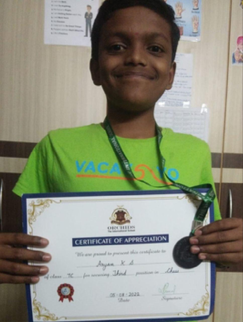 OMCA student with a certificate of appreciation and medal